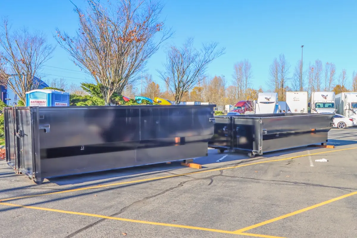 Professional dumpster rental service with roll-off container on residential driveway in Unionville